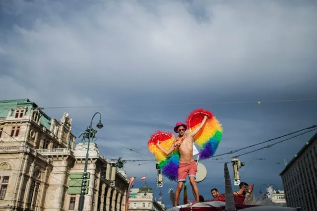 A participant dances on a truck in front of the Vienna State Opera during the 21st Rainbow Parade in Vienna, Austria, 18 June 2016. (Photo by Christian Bruna/EPA)