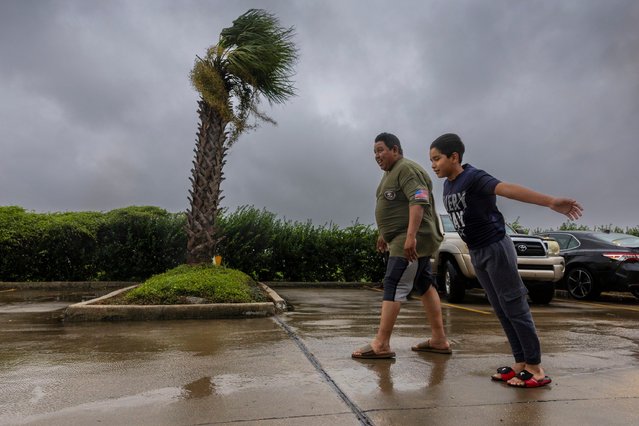 Lazaro Cardoso, 11, leans far into the powerful winds coming from the eye wall of Hurricane Francine as he and his dad, Hugo Gonzales, stay at a hotel Wednesday, September 11, 2024, in Houma, La., that was being powered by a generator. The family lives not far from the hotel but they decided to stay at it since they said they always lose power during powerful storms. (Photo by Chris Granger/The Times-Picayune/The New Orleans Advocate via AP Photo)