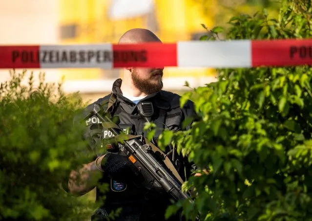 A police officer carrying a machine pistol stands guard outside the Kinopolis cinema in Viernheim, Germany, June 23, 2016. Police shot dead a man who is reported to have fired a weapon. (Photo by Andreas Arnold/DPA/Newscom)