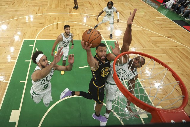 Golden State Warriors guard Stephen Curry (30) goes up for a shot against Boston Celtics center Al Horford (42) and guard Derrick White (9) during Game 4 of basketball's NBA Finals, Friday, June 10, 2022, in Boston. (Photo by Kyle Terada/Pool Photo via AP Photo)