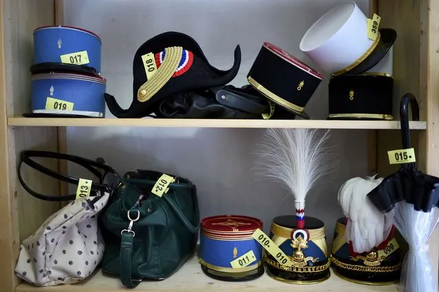 A picture shows a bicorn hat, an umbrella, bags and different types of flat-topped French military caps in a cloakroom at the Defence ministry in Paris, France, during the annual reception in honour of the French Armed Forces July 13, 2016. (Photo by Stephane De Sakutin/Reuters)