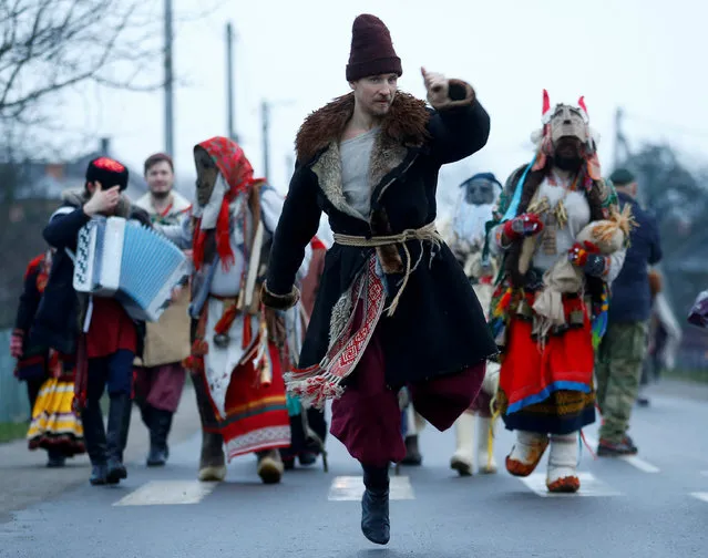 Artists of Imperial Russian Ballet take part in a festive procession called “Koniki” (Horses) as they visit houses, dance and sing to mark the New Year's Eve according to the Julian calendar, in the village of David-Gorodok, Belarus on January 13, 2020. (Photo by Vasily Fedosenko/Reuters)