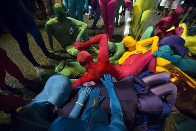 A group of people wearing full solid-coloured bodysuits take part in a street art performance in Bat Yam, near Tel Aviv, Israel August 29, 2015. (Photo by Amir Cohen/Reuters)