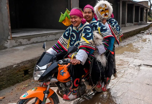 Tibetan in exile performers arrive on a motorbike before performing at the Boudhanath Stupa area during celebrations marking the third day of the Lhosar Tibetan New Year in Kathmandu on February 26, 2020. Lhosar, the New Year of the Tibetans, falls in February or March and is marked with feasts, family gatherings and the exchanging of gifts. (Photo by Prakash Mathema/AFP Photo)