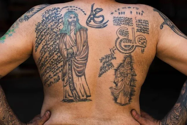 In this Tuesday, May 10, 2016 photo, Ali Hussein Nasreddine, 50, poses for a photo showing off his tattoos of Shiite Muslim religious slogans and Shiite Muslims' first Imam Ali, in the southern suburb of Beirut, Lebanon. (Photo by Hassan Ammar/AP Photo)