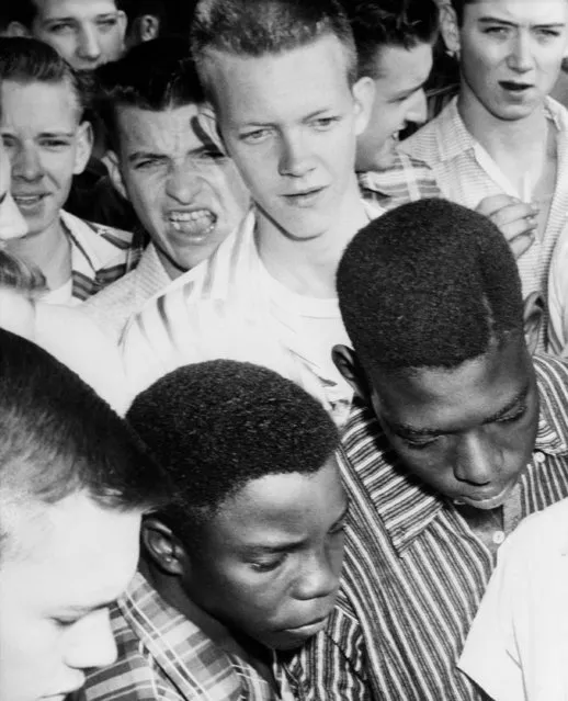 The face of the boy in the background reflects his feelings as he looks at two of the six black students who attempted to enter North Little Rock High School, Arkansas, September 9, 1957. The boy and other white students are not identified. The black youths are, Richard Richardson, 17, and Harold Smith, 17, right. (Photo by William P. Straeter/AP Photo)