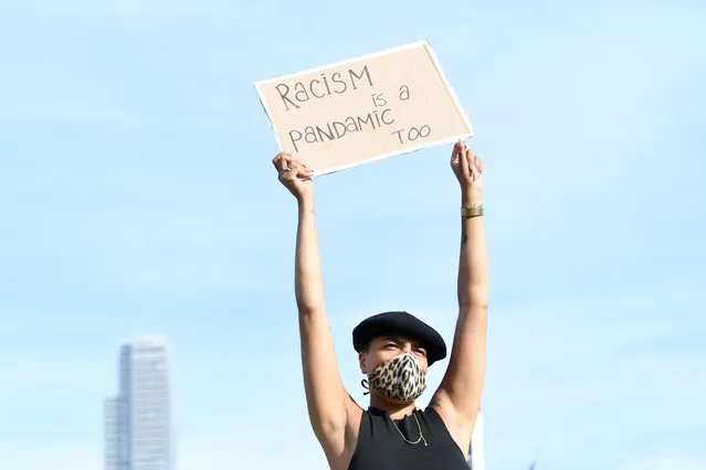 A demonstrator holds a sign during a protest against the death in Minneapolis police custody of George Floyd, in The Hague, Netherlands on June 2, 2020. (Photo by Piroschka van de Wouw/Reuters)