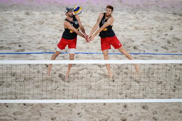 France's Julien Lyneel and Remi Bassereau return the ball to Poland's Michal Bryl and Bartosz Losiak during the volleyball Beach Pro Tour Elite 16 at the the Roland-Garros central court, in Paris, on September 29, 2022. (Photo by Anne-Christine Poujoulat/AFP Photo)