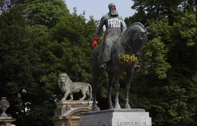 In this June 10, 2020, photo, a statue of Belgium's King Leopold II is smeared with paint and graffiti in the center of Brussels. With the protests sweeping the world in the wake of the killing of George Floyd in Minneapolis, King Leopold II, who reigned from 1865 to 1909, is now increasingly seen as a stain on the nation. (Photo by Virginia Mayo/AP Photo)