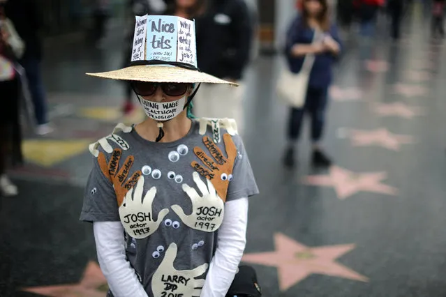 A woman who declined to give her name wears an outfit with the names of all the men in Hollywood who sexually harrassed her during a protest march for survivors of sexual assault and their supporters in Hollywood, Los Angeles, California U.S. November 12, 2017. (Photo by Lucy Nicholson/Reuters)