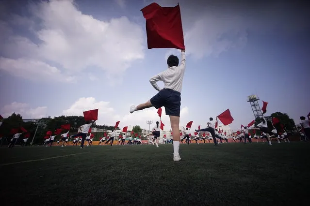 In this September 26, 2017, photo, students practice flag cheering Routines at a Tokyo Korean junior and senior high school in Tokyo. Many third- and fourth-generation descendants of Koreans brought to Japan during the imperialist years before and during World War II remain loyal to their roots. Families send children to private schools that favor North Korea and teach the language, culture and history of their ancestry. Despite recent North Korean missile launches and nuclear tests, students say they take pride and view their community as a haven from the discrimination they face from ethnic Japanese. (Photo by Eugene Hoshiko/AP Photo)