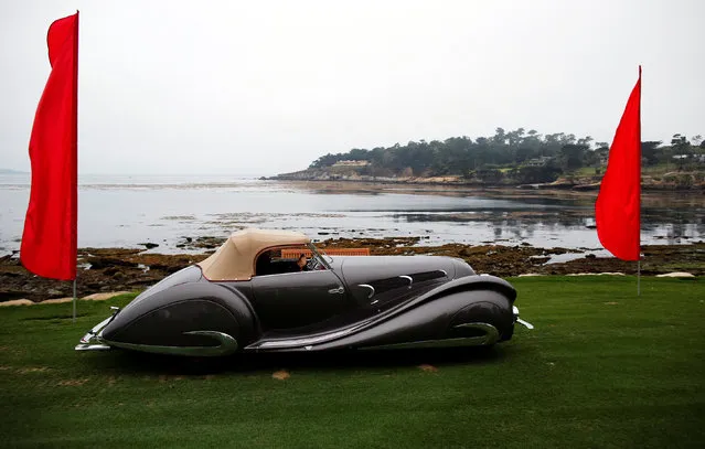A 1937 Delahaye 135 MS Figoni & Falaschi Special Roadster is driven onto the 18th fairway during the Concours d'Elegance in Pebble Beach, California, U.S. August 21, 2016. (Photo by Michael Fiala/Reuters/Courtesy of The Revs Institute)