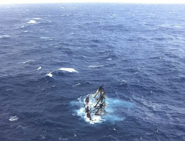 The HMS Bounty, a 180-foot replica of a famous 18th century merchant vessel, is shown submerged in the Atlantic Ocean during Hurricane Sandy about 90 miles southeast of Hatteras, N.C., on October 29, 2012. Of the 16-person crew, the Coast Guard rescued 14, recovered the body of woman crew member and is searching for the captain of the vessel. (Photo by Petty Officer 2nd Class Tim Kuklewski/USCG via Reuters)