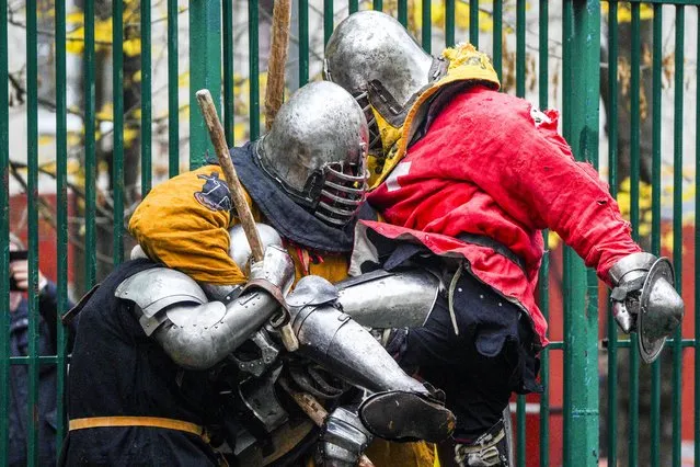 People wearing medieval armour components take part in a friendly fight event held in a basketball court to keep the medieval street fights alive in Russian capital Moscow on October 23, 2022. The “Tushino maneuvers”, or friendship fights between clubs, were created to preserve the traditional aspects of medieval street battles and pass them on to younger generations. These fights quickly gained popularity in the city. The warriors, who gather on specific days of the week and engage in combat while clad in steel armor, are highly regarded and admired by the populace. (Photo by Pelagiya Tikhanova/Anadolu Agency via Getty Images)
