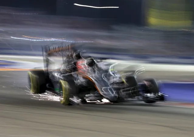 Force India Formula One driver Nico Hulkenberg of Germany collides with Williams Formula One driver Felipe Massa of Brazil during the Singapore F1 Grand Prix at the Marina Bay street circuit September 20, 2015. (Photo by Edgar Su/Reuters)