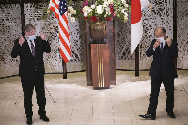U.S. Special Representative for North Korea Stephen Biegun, left, and Japanese Vice Foreign Minister Takeo Akiba, right, take off their protective masks for a photo session prior to their bilateral meeting at Iikura Guest House Thursday, July 9, 2020, in Tokyo. (Photo by Eugene Hoshiko/AP Photo/Pool)