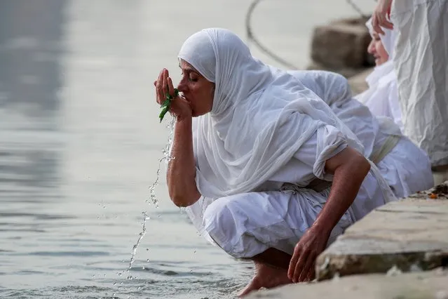 A woman in the Sabean Mandaean community takes part in a ritual during the Prosperity Day celebration in the Tigris River in central Baghdad, Iraq, Tuesday, November 1, 2022. (Photo by Hadi Mizban/AP Photo)