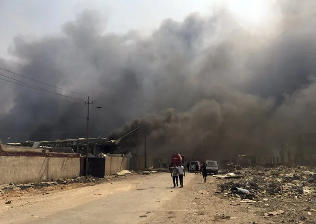 Smoke rises after explosions eastern Baghdad, Iraq, Friday, September 2, 2016. (Photo by Khalid Mohammed/AP Photo)