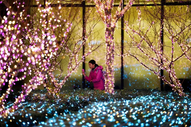 A girl walks past Christmas decorations in front of an office building in Beijing, China December 14, 2017. (Photo by Jason Lee/Reuters)