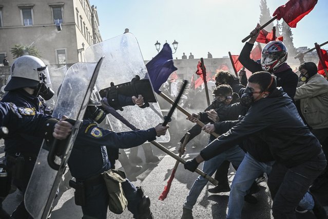 Students clash with riot police in front of the Greek Parliament during a demonstration against the government's plans for private universities, in Athens, on February 1, 2024. (Photo by Angelos Tzortzinis/AFP Photo)
