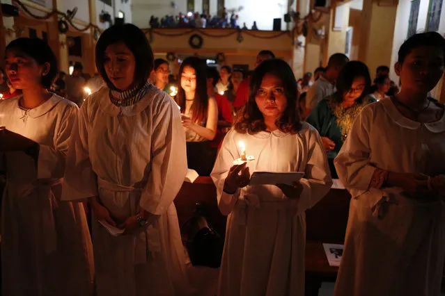 Indonesia Catholic congregation light candles to celebrate the Christmas Eve at the Hati Kudus Catholic Church in Banda Aceh, Indonesia, 24 December 2017. According to media reports, Indonesia deployed more than 90 thousand police personnel for the upcoming Christmas and New Year holidays in order to secure churches, tourist areas, and main roads around the country. (Photo by Hotli Simanjuntak/EPA/EFE)