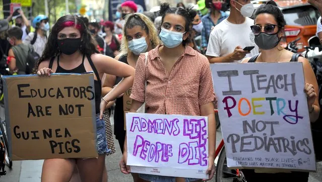 A coalition of teachers, students, and families protest during a rally called National Day of Resistance Against Unsafe School Reopening Opening, Monday, August 3, 2020, in New York. Organizers said New York Governor Andrew Cuomo, New York Mayor Bill DeBlasio, New York City Schools Chancellor Richard Carranza, and the Department of Education must stop the in-person reopening of schools until it is safe for all. (Photo by Bebeto Matthews/AP Photo)