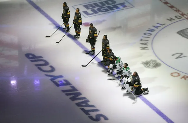 Dallas Stars' Jason Dickinson (18), Tyler Seguin (91) and Vegas Golden Knights' Ryan Reaves (75) and goalie Robin Lehner (90) take a knee for Black Lives Matter prior to an NHL hockey playoff game Monday, August 3, 2020 in Edmonton, Alberta. (Photo by Jason Franson/The Canadian Press via AP Photo)