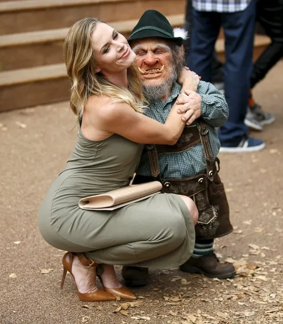 Actress Lauren Shaw poses with a person dressed as a leprechaun monster at the premiere of the film “Goosebumps”, in Los Angeles, California October 4, 2015. (Photo by Danny Moloshok/Reuters)