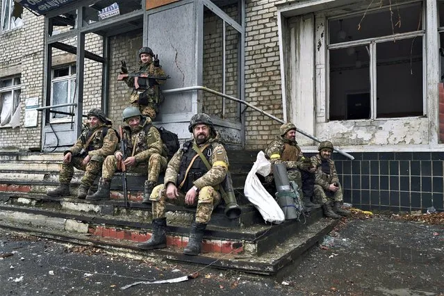 Ukrainian soldiers rest near their position in Bakhmut, Donetsk region, Ukraine, Saturday, December 17, 2022. (Photo by LIBKOS/AP Photo)