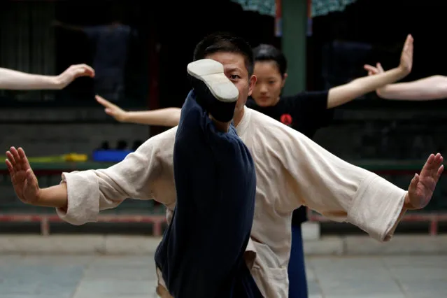 Kung Fu master Xing Xi teaches his students at his Kung Fu academy “Kung Fu Zen” in Beijing, China, July 3, 2016. (Photo by Kim Kyung-Hoon/Reuters)
