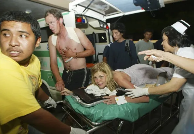 An injured tourist is sent to a hospital after a tsunami hit Phuket, south of Bangkok, in this December 26, 2004 file photo. (Photo by Chaiwat Subprasom/Reuters)