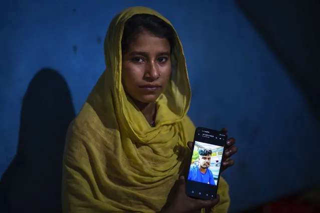 Sonali Begum, 17, displays a photo of her husband Siddique Ali, 23, who was picked up by the police, at her rented house in Guwahati, India, Saturday, February 4, 2023. Indian police have arrested more than 2,000 men in a crackdown on illegal child marriages in involving girls under the age of 18 a northeastern state. Begum is seven months pregnant. (Photo by Anupam Nath/AP Photo)