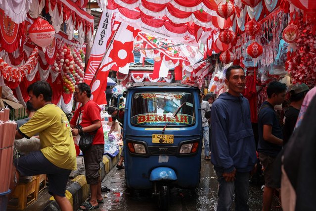 A rickshaw taxi drives past decoration materials for sale ahead of Indonesia's 80th Independence Day celebrations, at a traditional market in Jakarta, Indonesia, on August 12, 2025. (Photo by Ajeng Dinar Ulfiana/Reuters)