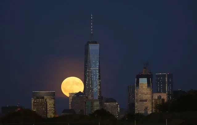 A harvest moon rises behind Lower Manhattan and One World Trade Center in New York City, September 16, 2016 as seen from Newark, New Jersey. (Photo by Gary Hershorn/Getty Images)