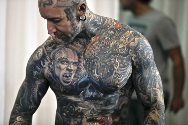 A man shows his tattoos during the International Tattoo Convention Bucharest 2016 in Bucharest, Romania, Sunday, October 16, 2016. Prominent tattoo artists from across the world displayed their skills in the Romanian capital over the weekend. (Photo by Vadim Ghirda/AP Photo)