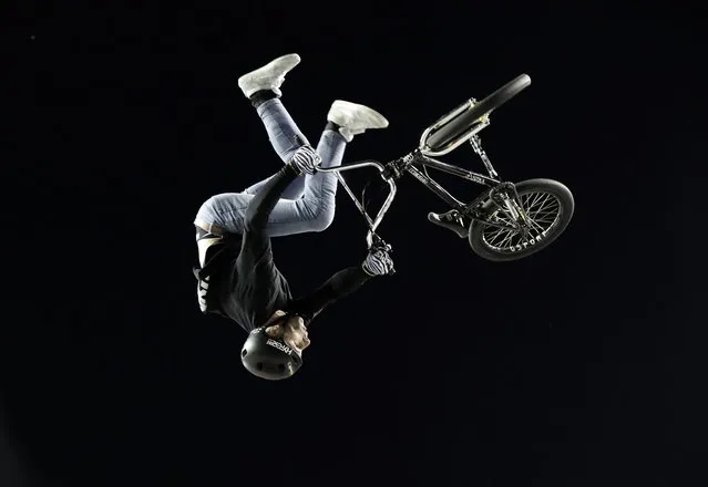 A cyclist performs stunts in an extreme sports exhibition during the Xknights event, in San Jose, Costa Rica, 11 March 2023. (Photo by Jeffrey Arguedas/EPA)
