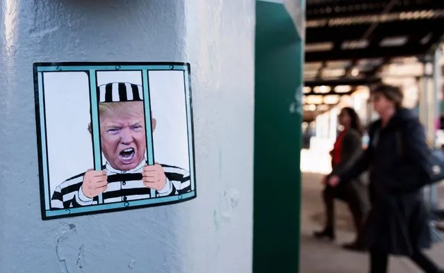 A sticker with the face of former President Donald J. Trump is displayed in front of New York Criminal Court in New York, New York, USA, 02 April 2023. A Manhattan grand jury voted to indict former President Donald J. Trump last week and he is reportedly planning to turn himself in at the courthouse and appear before a judge to hear the charges against him on 04 April. (Photo by Justin Lane/EPA/EFE)