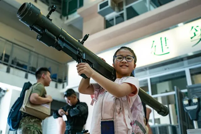 A girl holds up a mock MANPADS during the Hong Kong Police College open day as part of the National Security Education Day activities on April 15, 2023 in Hong Kong, China. Hong Kong chief executive John Lee on Saturday warned national security risks still exist after the implementation of the security law, as he vowed to press ahead with legislation to enact Article 23 of the Basic Law. (Photo by Anthony Kwan/Getty Images)