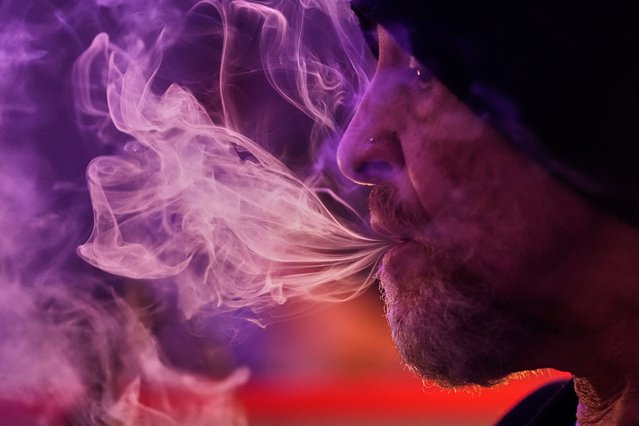 Miguel Laboy releases a stream of smoke while smoking cannabis in Brookline, Mass., October 3, 2025. (Photo by Robert F. Bukaty/AP Photo)