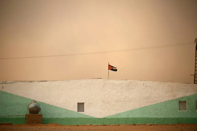 A Sahrawi Arab Democratic Republic flag flies at an indigenous Sahrawi refugee camp of Boudjdour, during a sand storm in Tindouf, southern Algeria September 10, 2016. (Photo by Zohra Bensemra/Reuters)