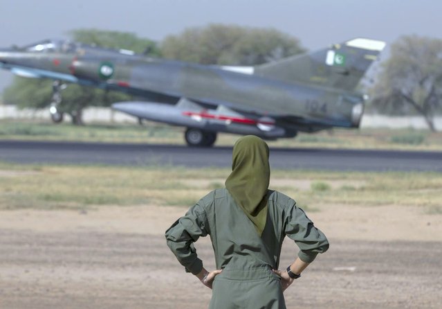 Ayesha Farooq, 26, Pakistan's only female war-ready fighter pilot watches an airforce jet about to take off at Mushaf base in Sargodha, north Pakistan June 7, 2013. (Photo by Zohra Bensemra/Reuters)