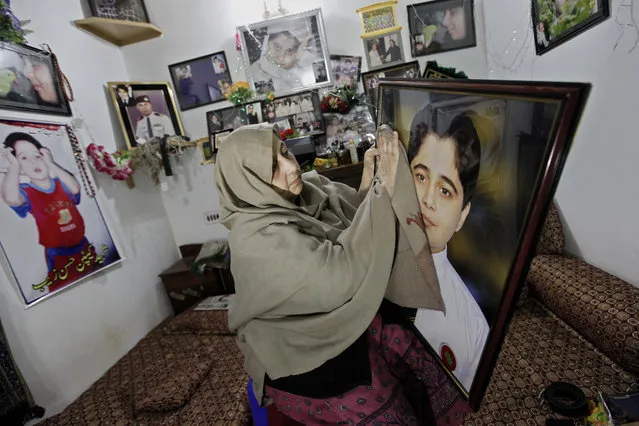 Nasra Zeb, motherr of Hasan Zeb one of the 132 students of Army Public School who were killed by Taliban militants, reacts in her son's room with his belongings, ahead of the first anniversary of school attack, in Peshawar, Pakistan, 14 December 2015. Seven Pakistani Taliban gunmen went from class to class on 16 December 2014 and killed more than 150 people, mostly students, at the Army Public School in Peshawar city. (Photo by Arshad Arbab/EPA)