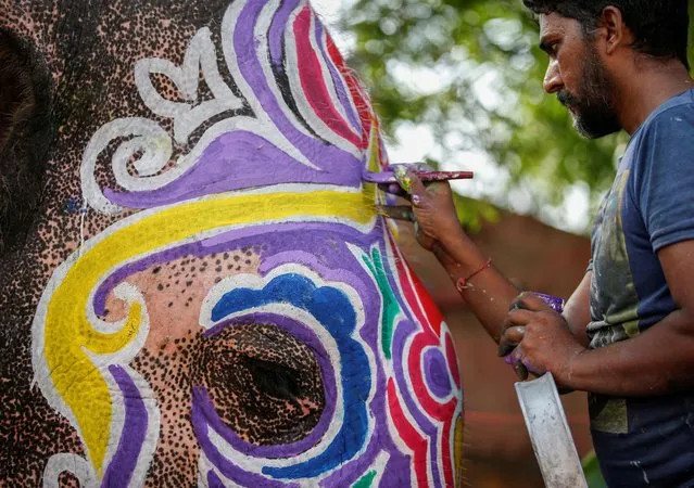 A mahout paints his elephant on the eve of the annual Rath Yatra, or chariot procession, outside the Jagannath temple in Ahmedabad, India on June 19, 2023. (Photo by Amit Dave/Reuters)