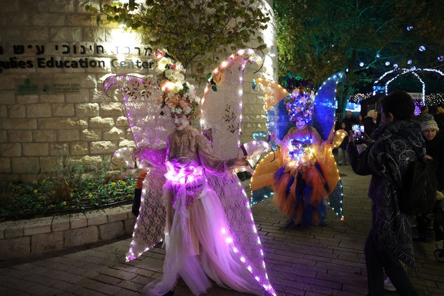 People visit the “Winter Dreams” international light exhibition at the botanical garden in Jerusalem, 05 December 2024. The Lights Exhibition features illuminated displays up to 5 meters high and 8 meters long, created using 3D technology by the European MK Illumination factory. The festival runs from 01 December until 31 January 2025. (Photo by Abir Sultan/EPA/EFE)