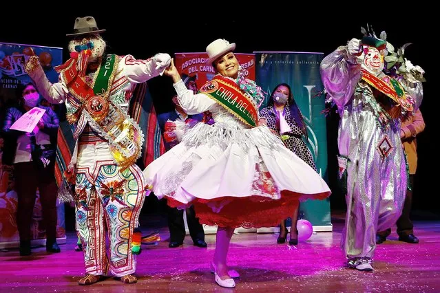 Contest winners celebrate at the end of a competition where they were selected as this year's Carnival characters: Pepino, right, Chola, center, and Chuta, all of whom represent gaiety in La Paz, Bolivia, Monday, February 8, 2021. The winning trio of Carnival must be adept at spreading happiness and never tire of dancing, however due to the COVID-19 pandemic, their performances will be broadcast online, and parades have also been canceled. (Photo by Juan Karita/AP Photo)