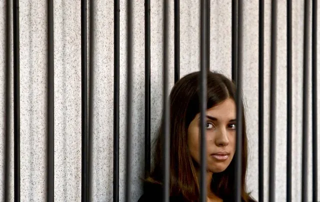 Nadezhda Tolokonnikova, of the female punk band “p*ssy Riot”, looks out from a holding cell as she attends a court hearing to appeal for parole at the Supreme Court of Mordovia in Saransk, Russia, on July 26, 2013. (Photo by Sergei Karpukhin/Reuters)