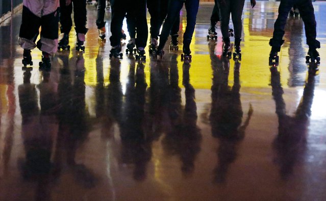Roller skaters cast shadows on the floor during an evening session at Rich City Skate in Richton Park, Illinois, January 12, 2015. (Photo by Jim Young/Reuters)