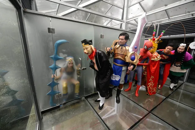 This picture taken on November 19, 2016 shows cosplay actors posing for photos in a glass public toilet to mark World Toilet Day in Changsha in China's central Hunan province. The World Toilet Organisation holds an annual World Toilet Day on November 19 to raise awareness of toilet hygiene and sanitation. (Photo by AFP Photo/Stringer)