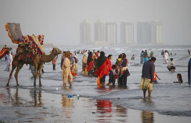 People gather at the beach despite governments restrictions amid third wave of coronavirus, that was reported across the country in Karachi, Pakistan, 07 April 2021. Pakistani authorities imposed smart lockdowns in an effort to curb the outbreak of third wave of infections with covid19. (Photo by Shahzaib Akber/EPA/EFE)