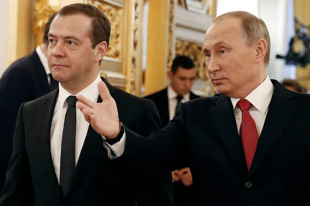 Russian President Vladimir Putin and Prime Minister Dmitry Medvedev walk after the president delivered his annual state of the nation address at the Kremlin in Moscow, Russia December 1, 2016. (Photo by Dmitry Astakhov/Reuters/Sputnik)